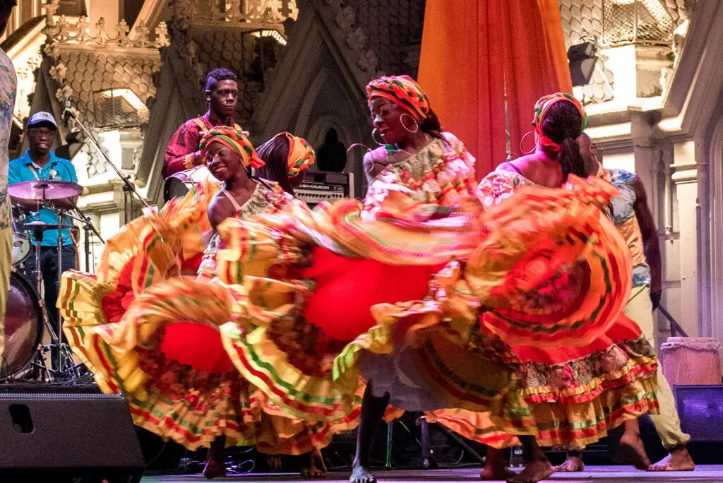Energetic dancers in festive attire on stage