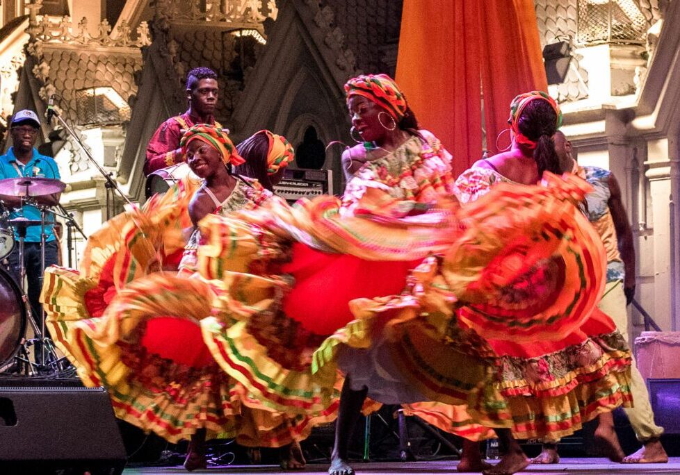 Energetic dancers in festive attire on stage